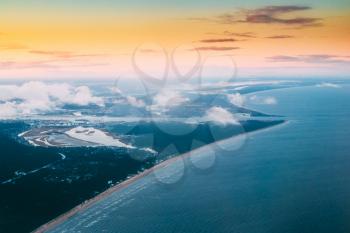 Western Dvina Flows Into The Baltic Sea. River Divides The Northern And Kurzeme District Of Riga, Latvia. View From Airplane Window. Sunset Sunrise Over Gulf Of Riga, Bay Of Riga, Or Gulf Of Livonia