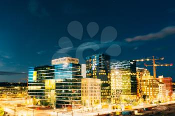 Oslo, Norway. The Night Panoramic View Of Contemporary District Of Black And White High-Rised Buildings In The Center Of City In Bright Illumination In Summer Evening, Blue Sky Background, Copyspace.