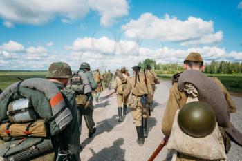 Unidentified re-enactors dressed as German and Soviet Russian soldiers 
during march