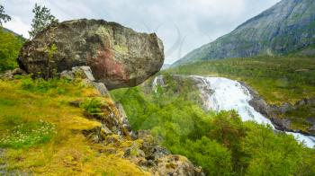 Landscape with Giant Tall Waterfall in the Valley of waterfalls in Norway. Husedalen Waterfalls were a series of four giant waterfalls in the South Fjord.