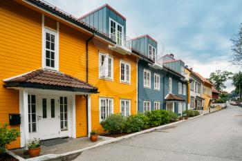 Bergen, Norway. The Colorful Facades Of Houses On Deserted Street At Residential Area In Summer Day Under Somber Sky.