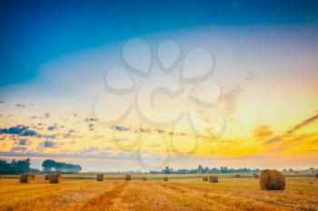 Sunset Field, Hay Bale In Belarus. Haystack In Field On Sunrise Sky Background. HDR.