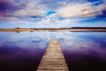 Old Wooden Pier. Calm River Nature Background. Autumn Season. Toned Instant Filtered Photo Image