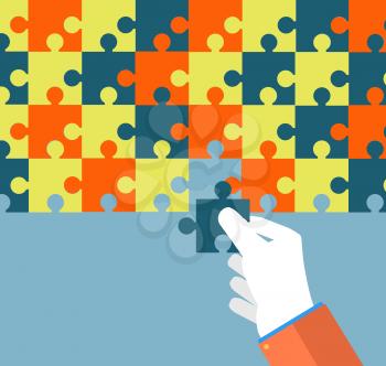Person making a puzzle. A hand puts proper puzzle. Businessman assembling jigsaw puzzle. Business concept