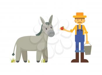 Mustachioed farmer in yellow shirt, blue robe and straw hat cartoon character feeding donkey with red apple vector illustration isolated on white.