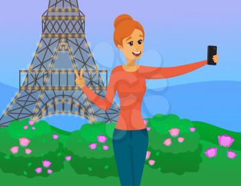 Girl is traveling in Paris and taking selfie on background of Eiffel Tower. Woman is photographed on phone camera near landmark. Lady with smartphone is posing for self portrait during tour in france