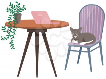 Table with laptop and cat on chair in interior of workplace. Modern workplace with furniture and kitten sitting on chair. Arrangement of furniture at place for working with technology at home