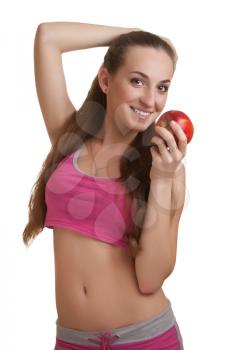 Athletic woman with an apple, isolated on white