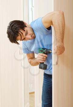 man repairing the door handle furniture