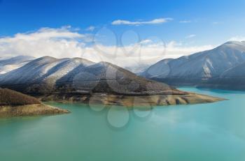 A beautiful view of Caucasus Mountains, surrounded by lake, which is an important feature of the landscape.