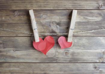 two red hearts hanging with clothespin on the rope. love concept