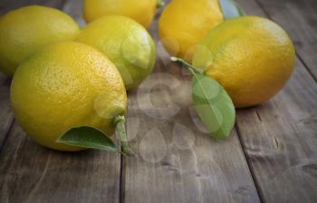 lemons with leafs on the old wooden table