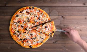Pizza with cheese and pizza paddle on wooden table background