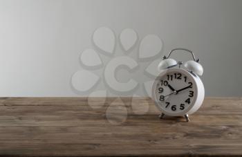 alarm clock on an old wooden table