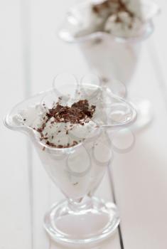 glass of ice cream with chocolate sprinkles on a wooden table