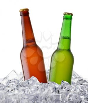 two beer bottles getting cool in ice cubes. Isolated on a white background.