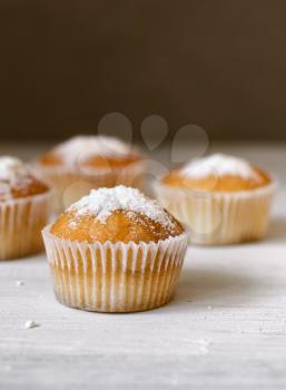 homemade baking muffins over white wooden board