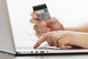 human  holding credit card and using laptop. Online shopping