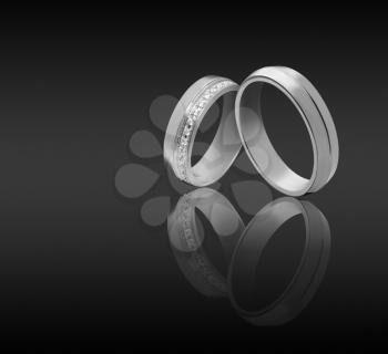 couple wedding engagement rings on dark background
