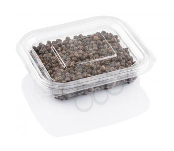 black pepper seeds in a transparent plastic container isolated on a white background, with clipping path