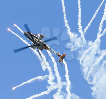 LEEUWARDEN,FRIESLAND,HOLLAND-SEPTEMBER 17:: Apache AH-64D Solo Display Team shoots flares at the Airshow on September 17, 2011 at Leeuwarden Airfield, Friesland, Holland.