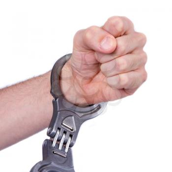 A man in metal handcuffs on a white background
