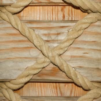 Ship ropes in the form of an X on a wood background(Holland)