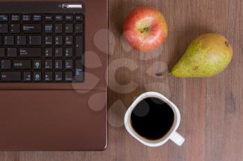 Fruit and coffee with a laptop on a wood floor