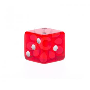 One transparent red die on a white background