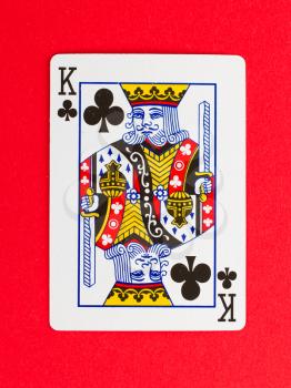 Old playing card (king) isolated on a red background