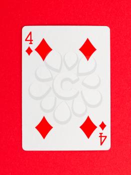 Old playing card (four) isolated on a red background