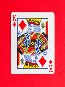 Playing card (king) isolated on a red background