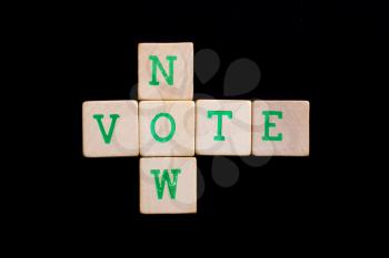 Letters on wooden blocks (now, vote)