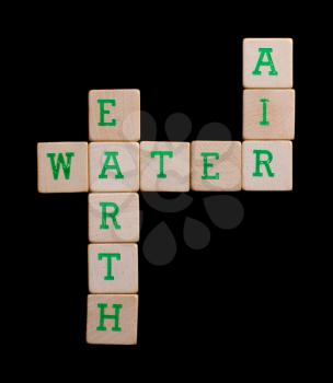 Green letters on old wooden blocks (earth, water, air)