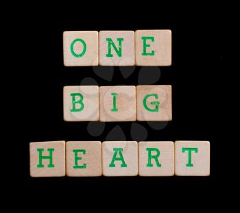 Green letters on old wooden blocks (one, big, heart)