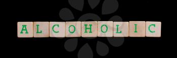 Alcoholic spelled out in old wooden blocks