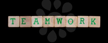 Green letters on old wooden blocks (teamwork)