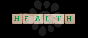 Green letters on old wooden blocks (health)