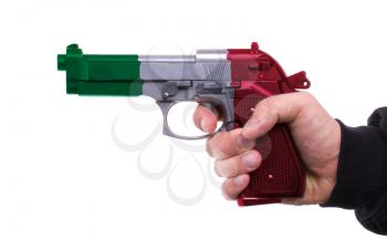 Pistol with Italian flag pattern in hand, isolated on white background