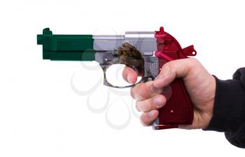 Pistol with Mexican flag pattern in hand, isolated on white background