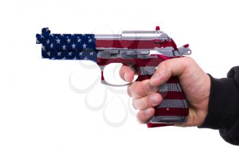 Pistol with USA flag pattern in hand, isolated on white background