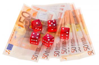 Red dice on top of some 50 euro banknotes