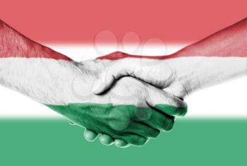 Man and woman shaking hands, wrapped in flag pattern, Hungary