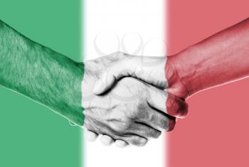 Man and woman shaking hands, wrapped in flag pattern, Italy