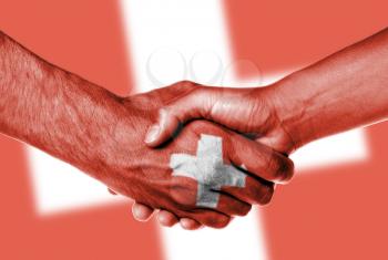 Man and woman shaking hands, wrapped in flag pattern, Switzerland