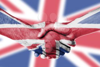Man and woman shaking hands, wrapped in flag pattern, United Kingdom