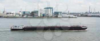 ROTTERDAM, THE NETHERLANDS - JUNE 22: Small chemical tanker sailing in the port of Rotterdam (Holland), Rotterdam, June 22, 2012