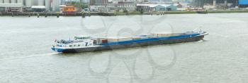 ROTTERDAM, THE NETHERLANDS - JUNE 22: Inland waterway transportation - motor cargo barge in the harbor of Rotterdam (Holland), Rotterdam, June 22, 2012
