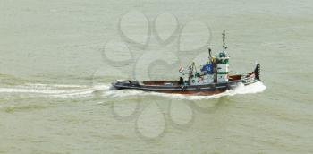 ROTTERDAM, THE NETHERLANDS - JUNE 22: Old tugboat is working in the harbor of Rotterdam (Holland), Rotterdam, June 22, 2012