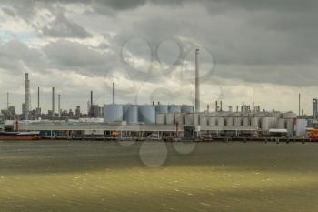 Dark clouds in the sky above the oil refineries in the dutch harbor of Rotterdam
